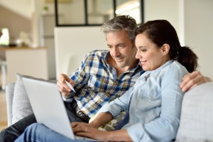 couple at home work to Compare Medicare Plans