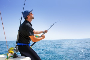 man fishing on a boat once he Compare Medicare Plans