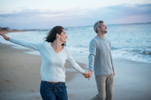 couple on beach happy after preparing for medicare